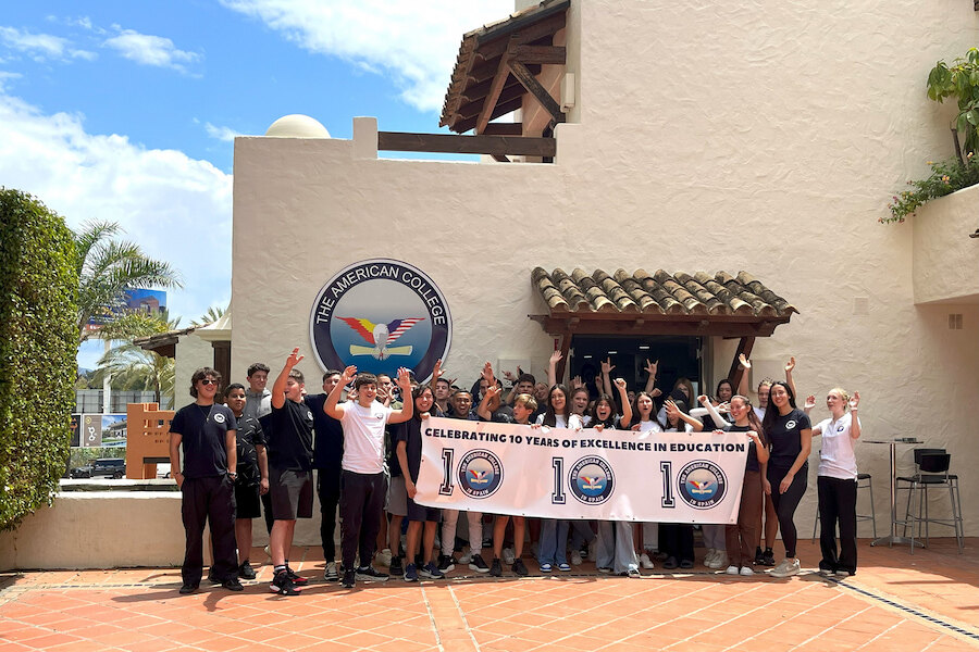 Students gathered outside The American College in Marbella celebrating an educational milestone