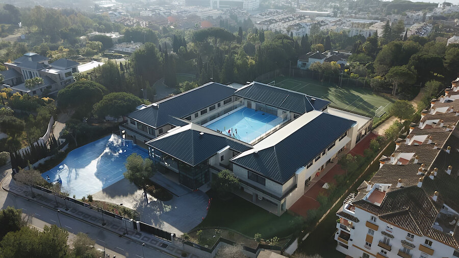 Modern international school campus in Marbella with outdoor sports facilities and landscaped surroundings