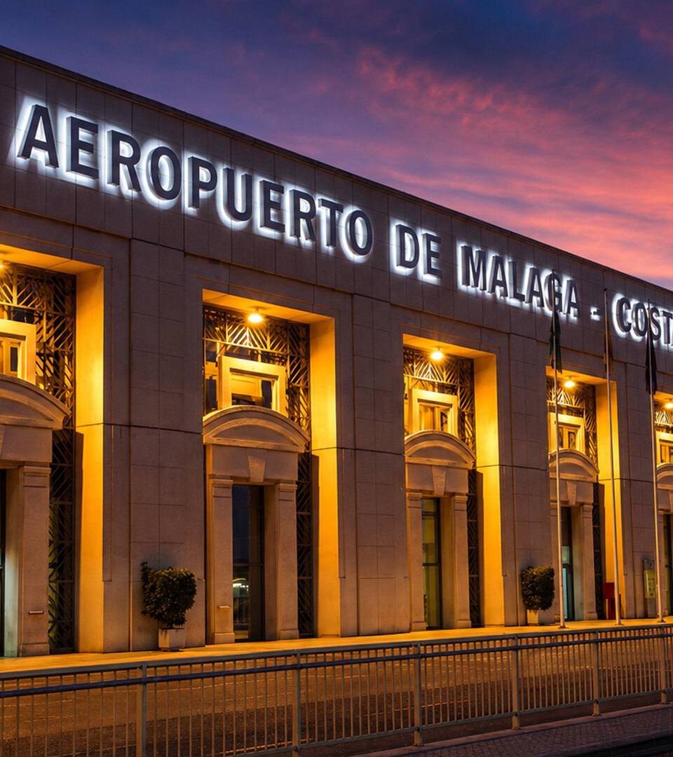 Exterior of Málaga Airport and Marbella property buyers arriving to the Costa del Sol at sunset.