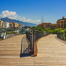 Modern boulevard footbridge in San Pedro de Alcántara with La Concha mountain in the background, reflecting the contrast between urban renewal and san pedro history.