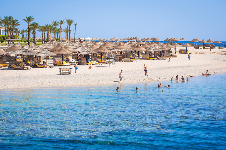 Marbella beach with thatched parasols, pale sand and crystal-clear water, one of the most popular Marbella attractions