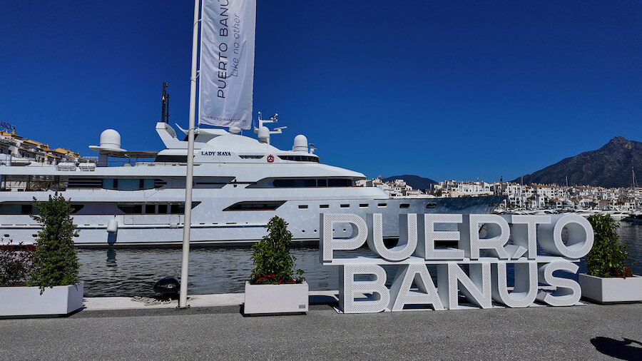 Puerto Banús, one of the top Marbella attractions, with a luxury yacht and the marina sign