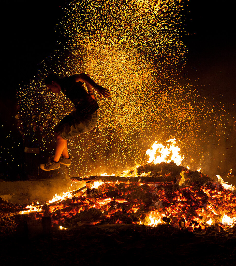 San Juan night in Marbella: Traditional fire-jumping scene.