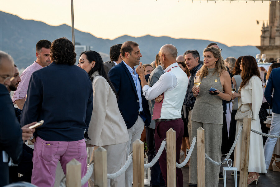 Guests networking during the General Meeting GIPE cocktail reception on a rooftop terrace in Málaga.