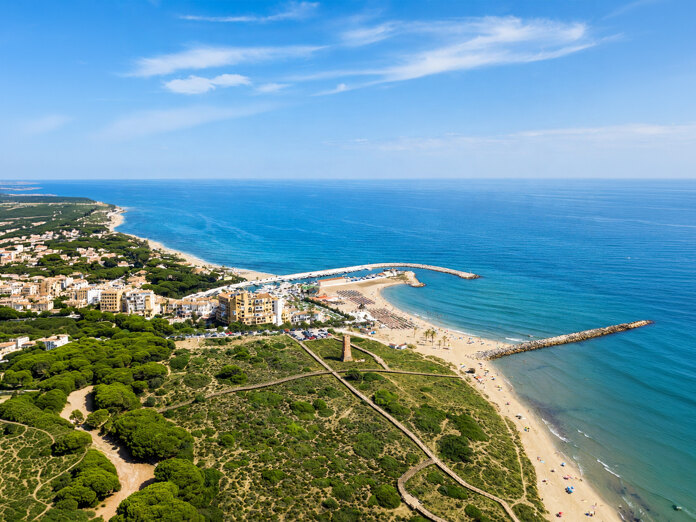 Aerial view of Cabopino beach, marina and protected dunes along the Marbella East coast
