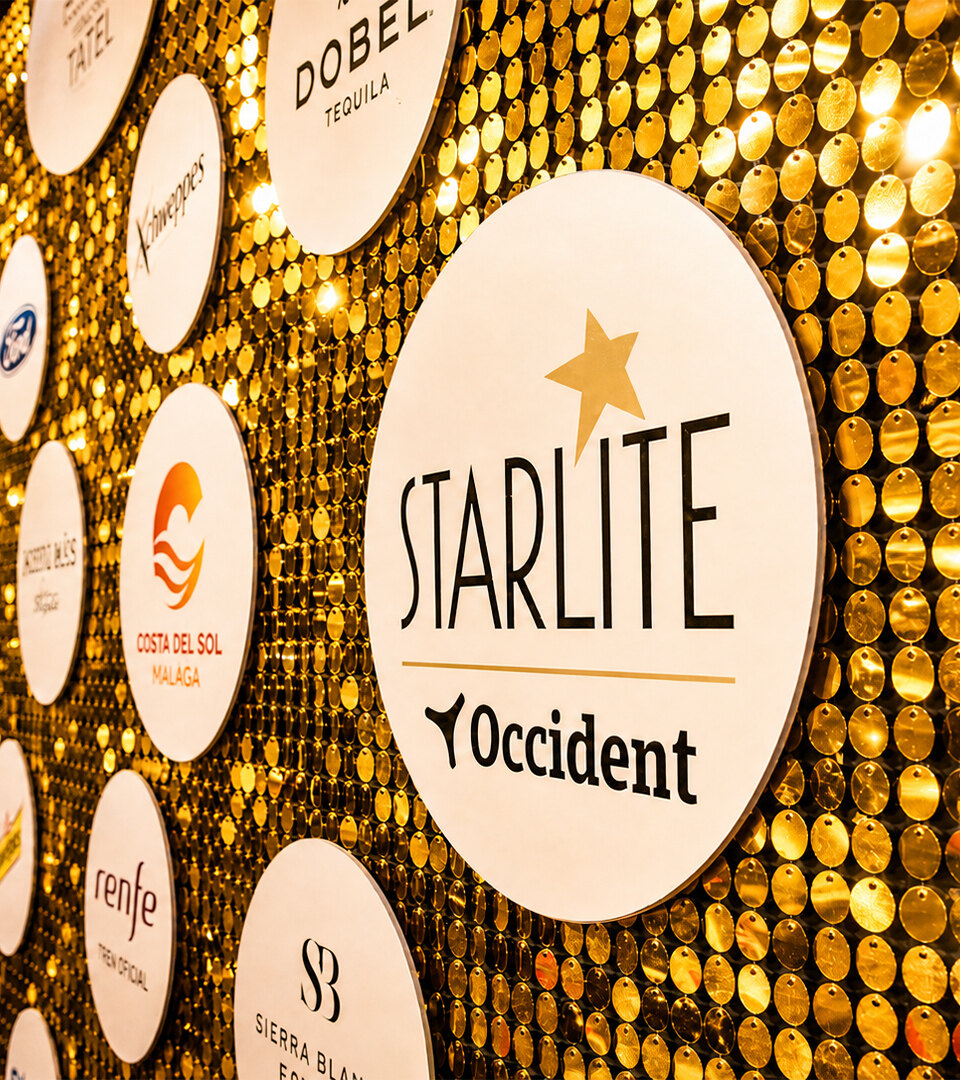 A golden sponsor wall at Starlite Marbella 2026 displaying the Starlite Occident logo and partner branding.