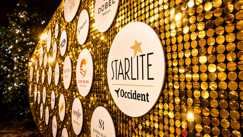 A golden sponsor wall at Starlite Marbella 2026 displaying the Starlite Occident logo and partner branding.