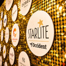 A golden sponsor wall at Starlite Marbella 2026 displaying the Starlite Occident logo and partner branding.