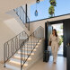 Elegant arrival at a turnkey home in Marbella with bright interiors, a sculptural staircase and garden views.