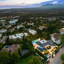 Aerial view of an exclusive residential area in Marbella with luxury villas, sea views and mountain backdrop