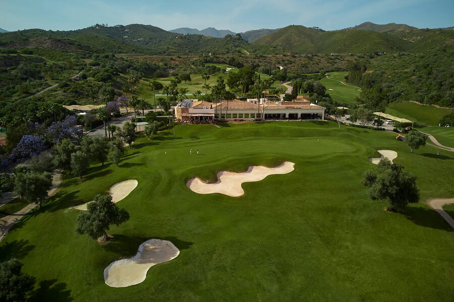 Scenic golf course in Marbella East surrounded by green hills and Mediterranean landscape