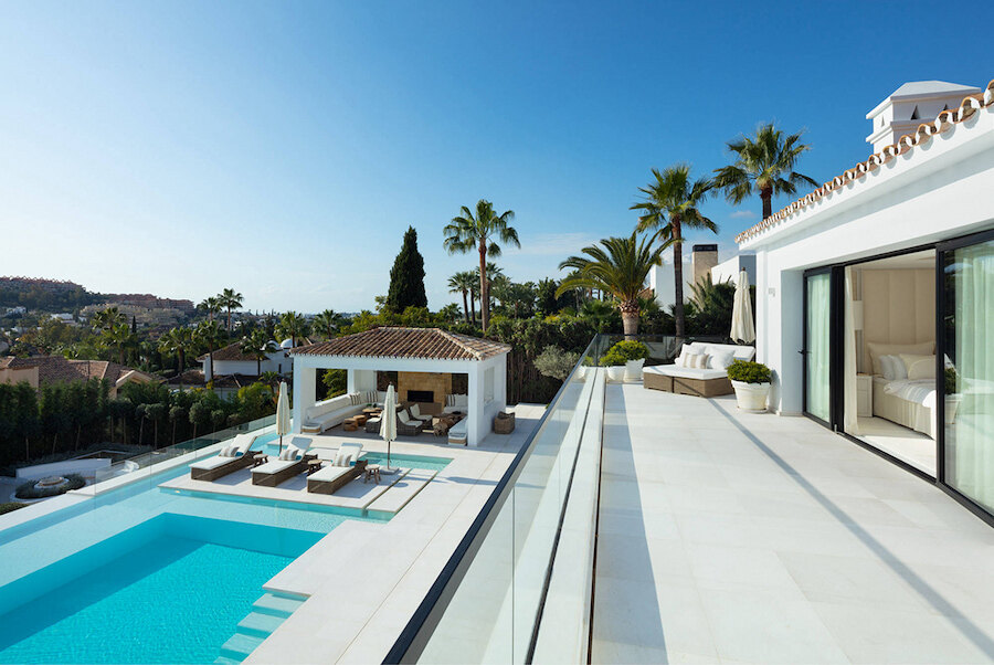 Terraza privada de una de las villas en venta en el sur de España, con piscina infinita, vistas al mar y elegantes espacios exteriores.