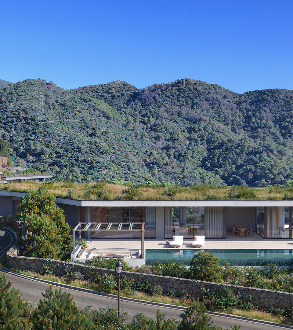 Single-storey modern villa with green roof and pool surrounded by mountains, showing the evolving design of Marbella