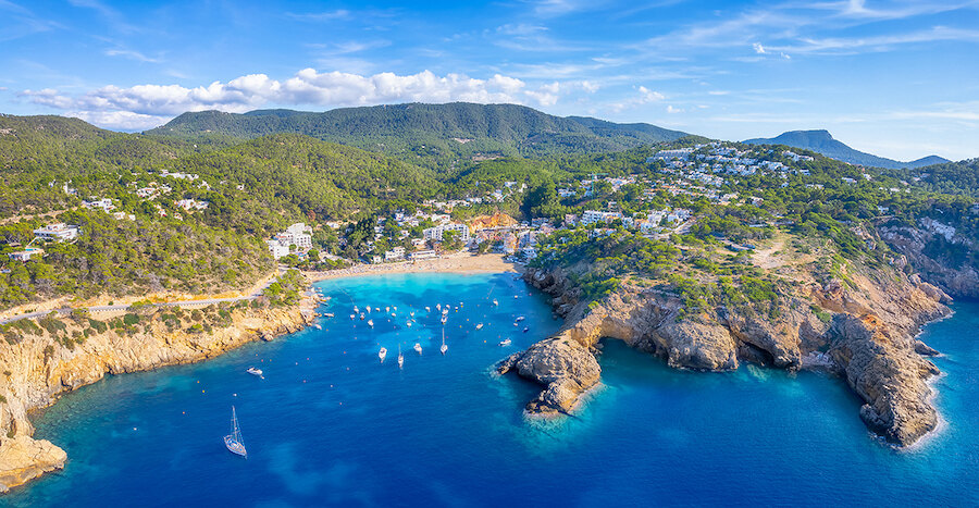 Turquoise waters and yachts reflecting Marbella vs Ibiza coastal living
