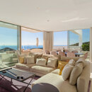 duplex penthouses. Contemporary open-plan living and dining area with floor-to-ceiling windows, terrace, and panoramic sea and mountain views