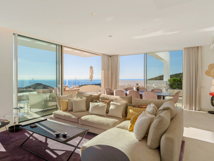 duplex penthouses. Contemporary open-plan living and dining area with floor-to-ceiling windows, terrace, and panoramic sea and mountain views