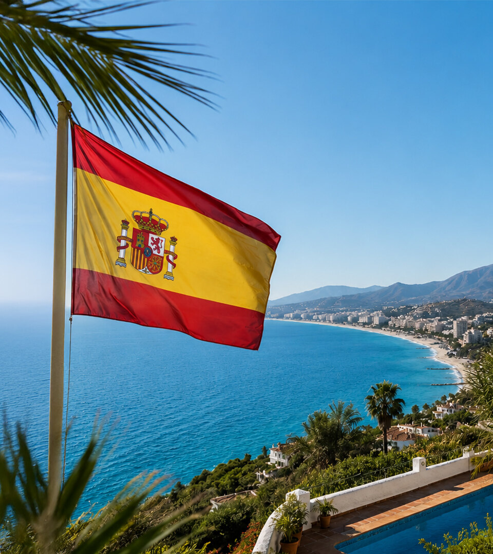 Spanish flag overlooking the Mediterranean coast, palm trees and villas, reflecting the quality of life in Spain.