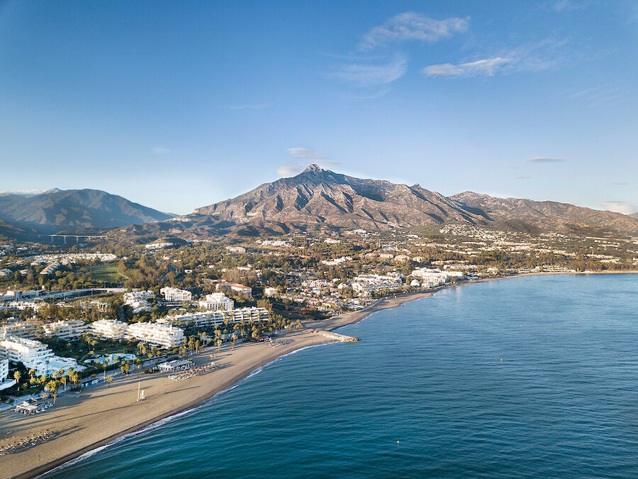 Aerial view of the Costa del Sol featuring Marbella, its beaches, and La Concha mountain in the background.