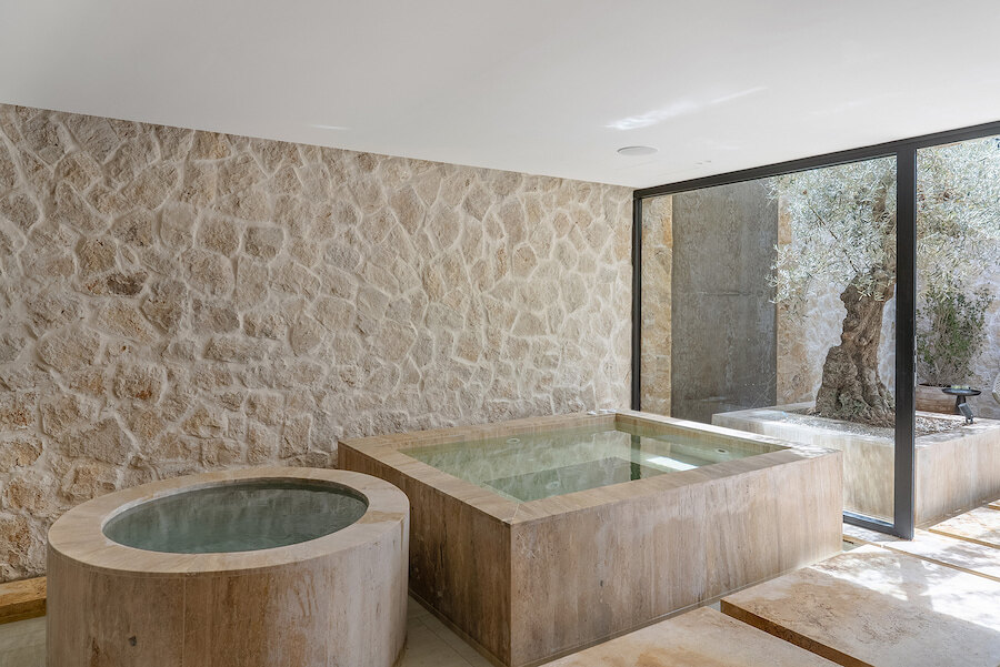 Stone spa area with jacuzzi and cold plunge in a luxury villa