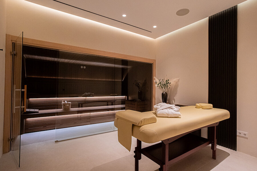 Massage room with treatment bed and sauna