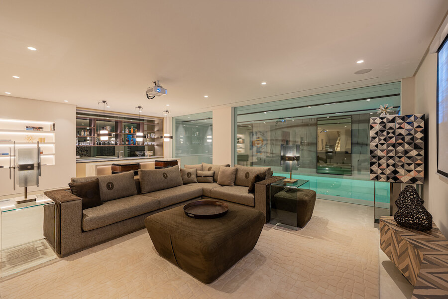 Elegant lounge and home cinema overlooking a private indoor pool in a Marbella spa villa