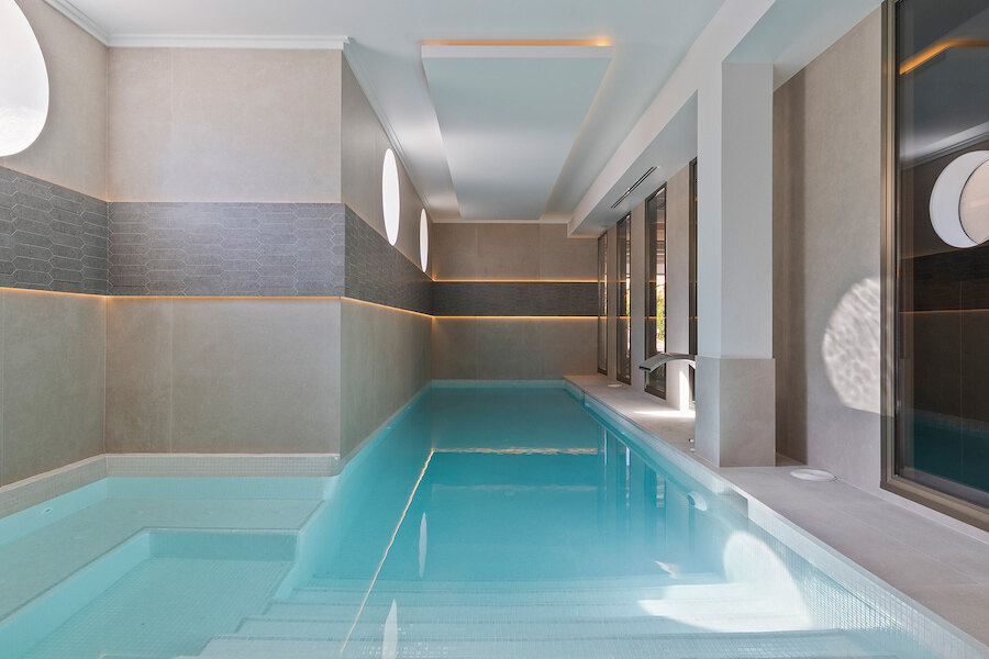 Minimalist indoor wellness pool with soft lighting in a luxury villa in Marbella with spa