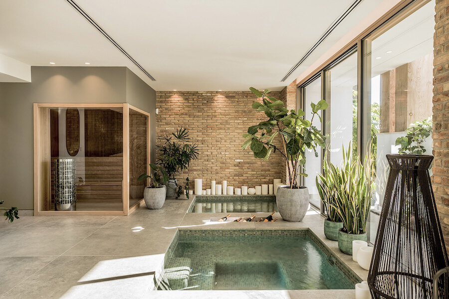 Private wellness area with sauna, plunge pools and plants inside a Marbella villa with spa