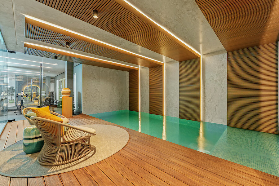 Designer indoor spa pool with wooden deck and gym in a luxury Marbella villa