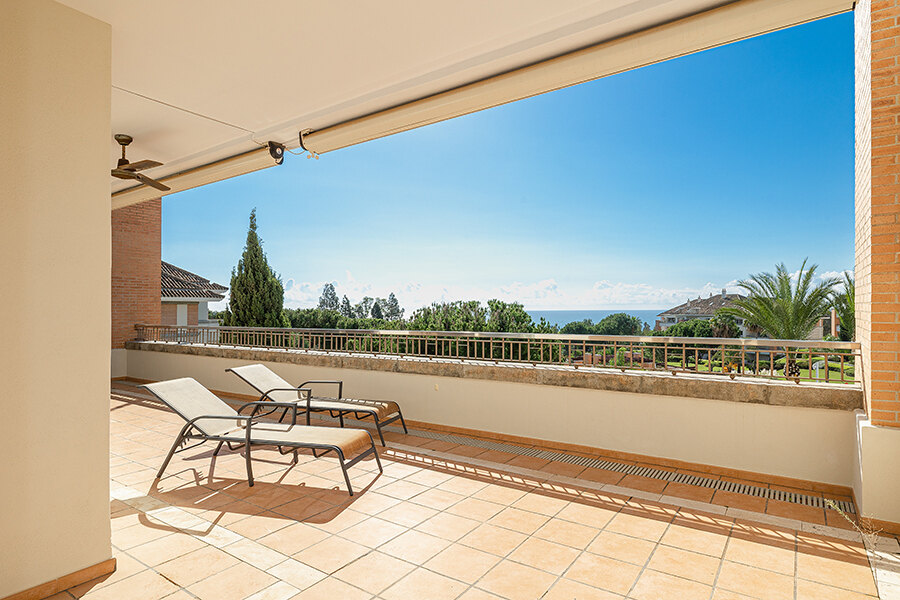 Spacious terrace of a property in La Trinidad Marbella, with breathtaking sea views and room for outdoor dining.