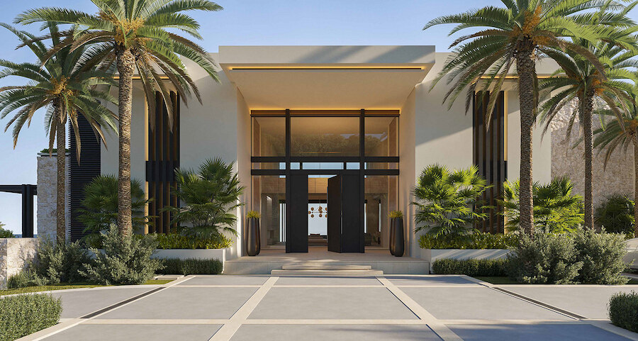 Contemporary villa entrance with tall glass doors, sleek architecture, palm trees and manicured landscaping.