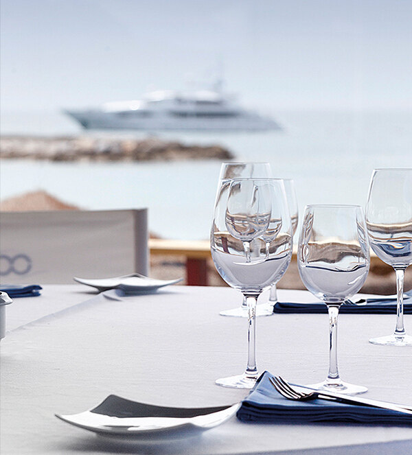 Marbella lifestyle. Table set for dinner next to the entrance to Marbella marina