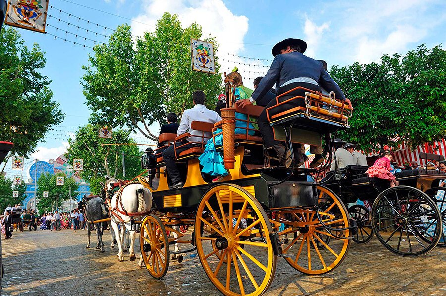 Horse carriages parade around the fairground