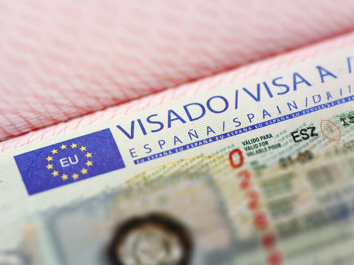 Close-up of an official visa for Spain inside a passport, with the European Union logo and validity details partially visible.