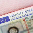 Close-up of an official visa for Spain inside a passport, with the European Union logo and validity details partially visible.