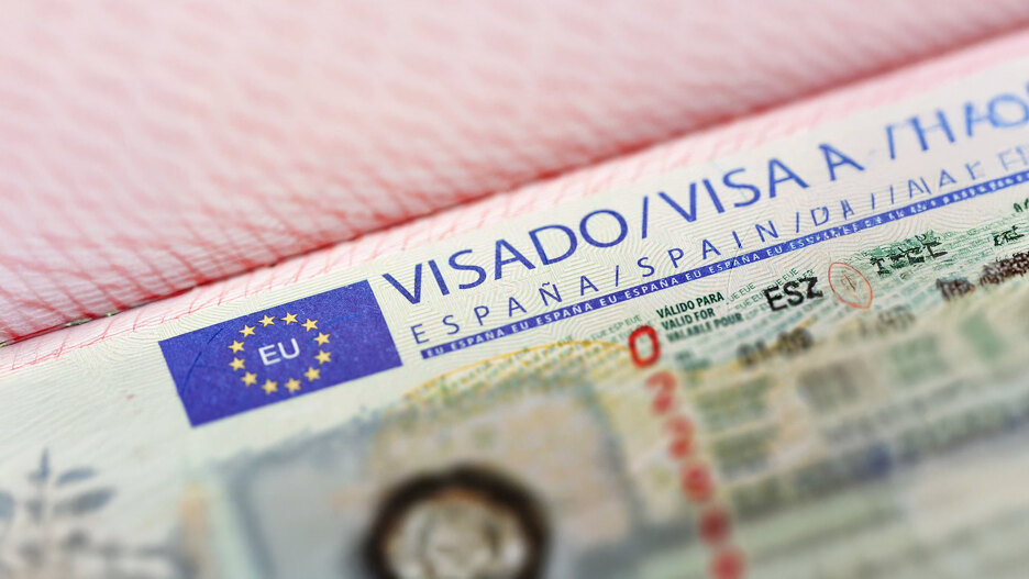 Close-up of an official visa for Spain inside a passport, with the European Union logo and validity details partially visible.