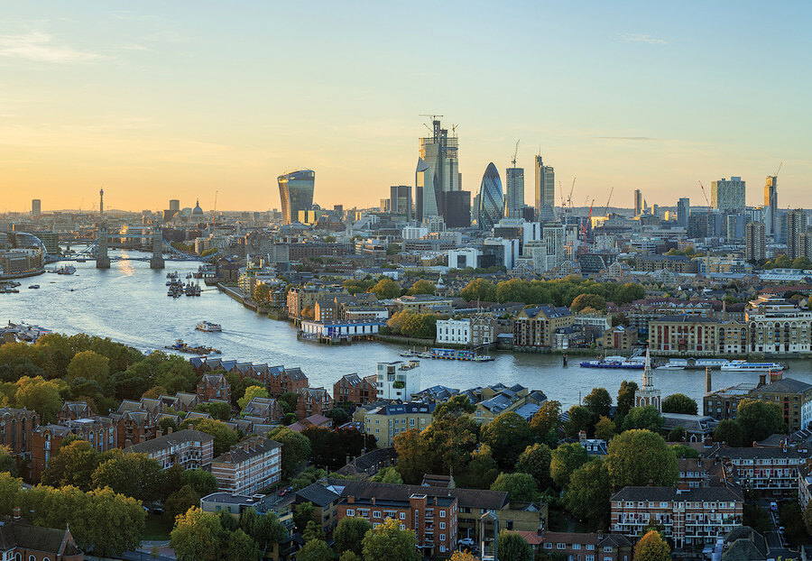 Panoramic view of central London at sunset, with the River Thames, Tower Bridge, and the iconic skyline featuring buildings like the Walkie Talkie and The Gherkin. John D Wood & Co. has over 150 years of experience and represents more than 100,000 properties worldwide.