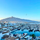 Panoramic view of Puerto Banús marina in Marbella, with rows of luxury yachts, whitewashed buildings, and the iconic La Concha mountain in the background. The clear blue sky and calm Mediterranean waters highlight the beauty of this exclusive coastal destination.