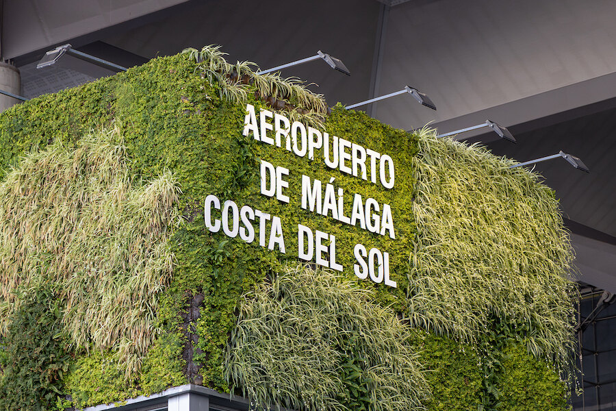 Malaga airport's. Sign reading “Aeropuerto de Málaga Costa del Sol” on a green vertical garden wall at Málaga Airport.